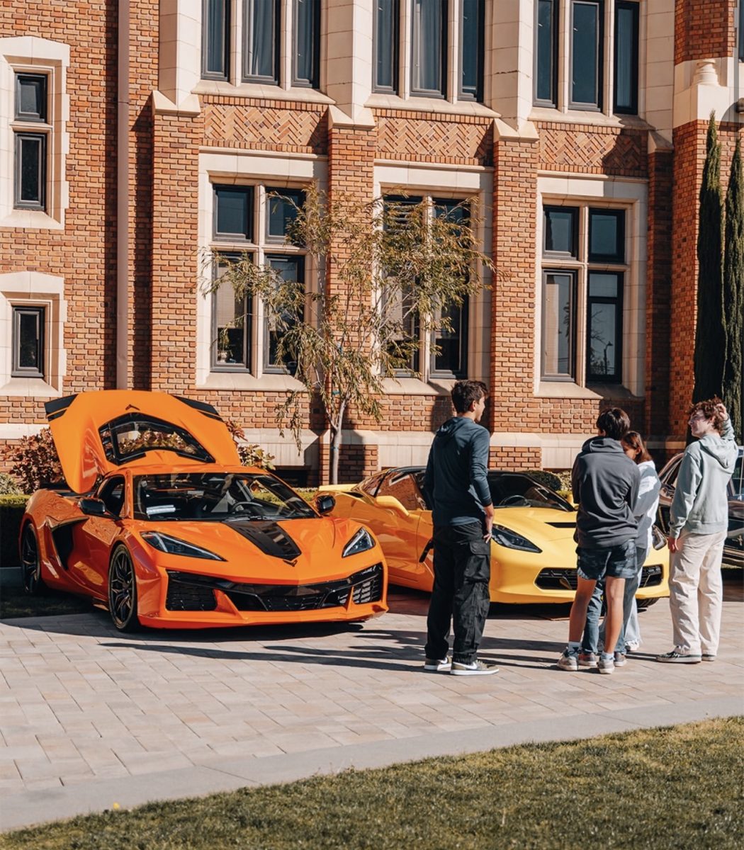 STUDENTS explore the car show.